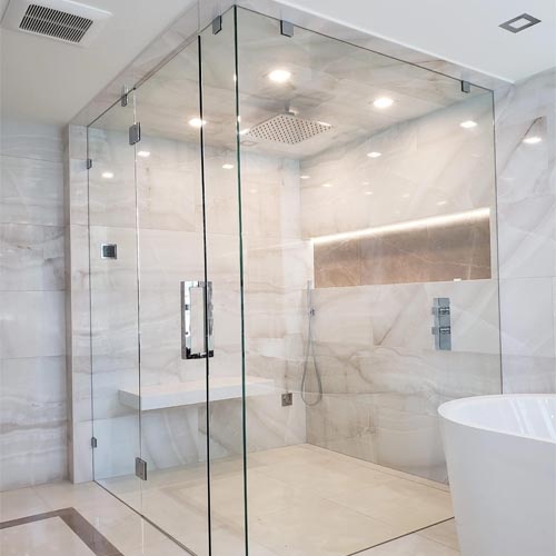 Frameless glass shower enclosure